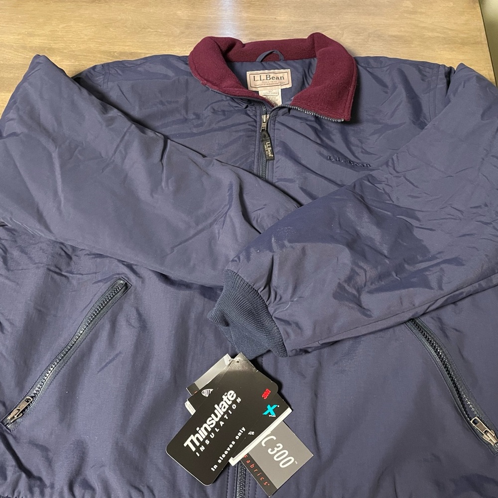 Navy Blue zip up performance jacket.